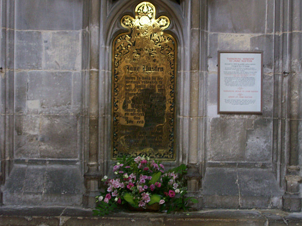 The gold plaque on the wall by Austen's grave