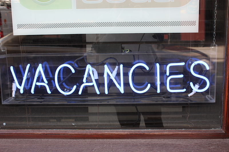 A photo of a window with a vacancies sign