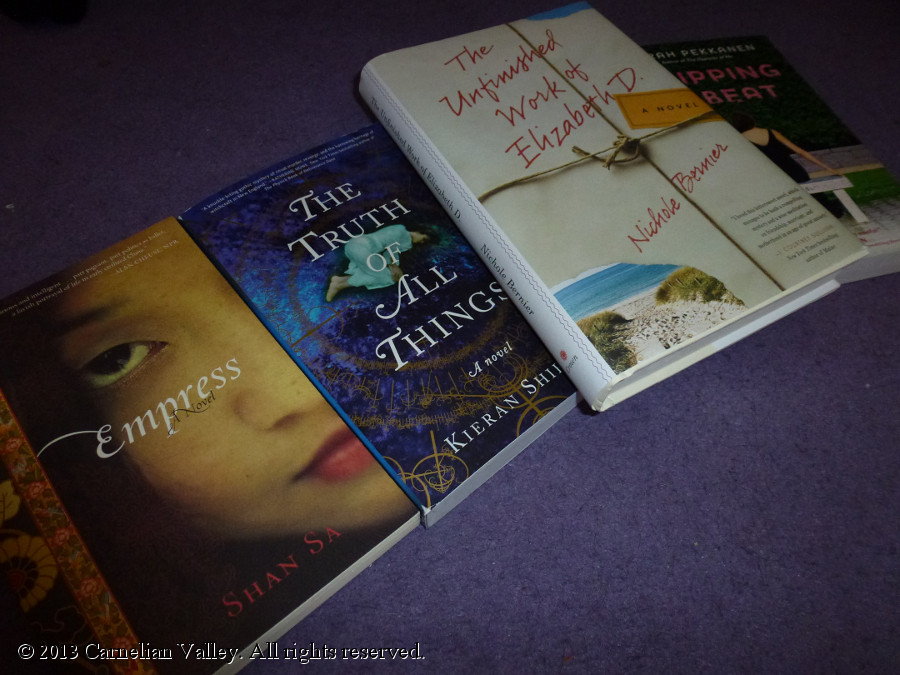 A photograph of four books: Shan Sa's Empress, Kieran Shield's The Truth Of All Things, Nichole Bernier's The Unfinished Work Of Elizabeth D, and Sarah Pekkanen's Skipping A Beat