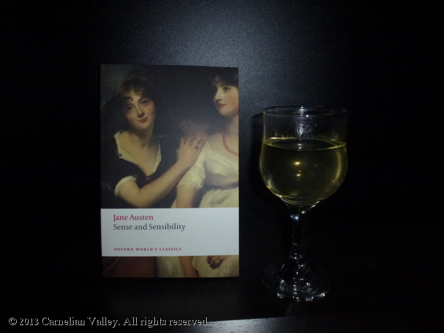 A photo of a copy of Sense And Sensibility beside a glass of wine