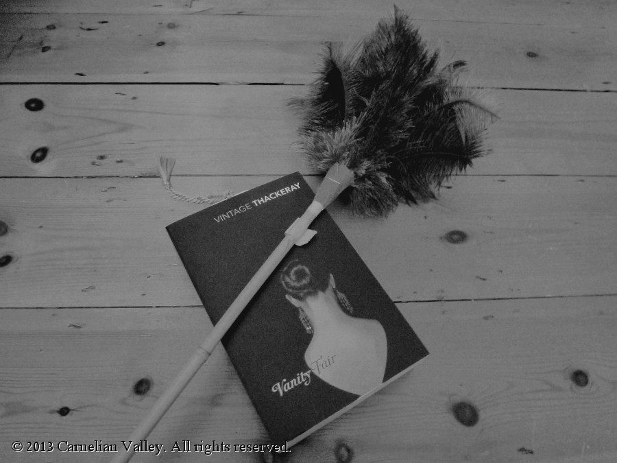 A photo of a copy of Vanity Fair and a feather duster