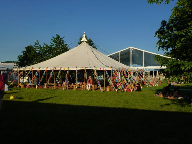 A photograph of a tent on a green