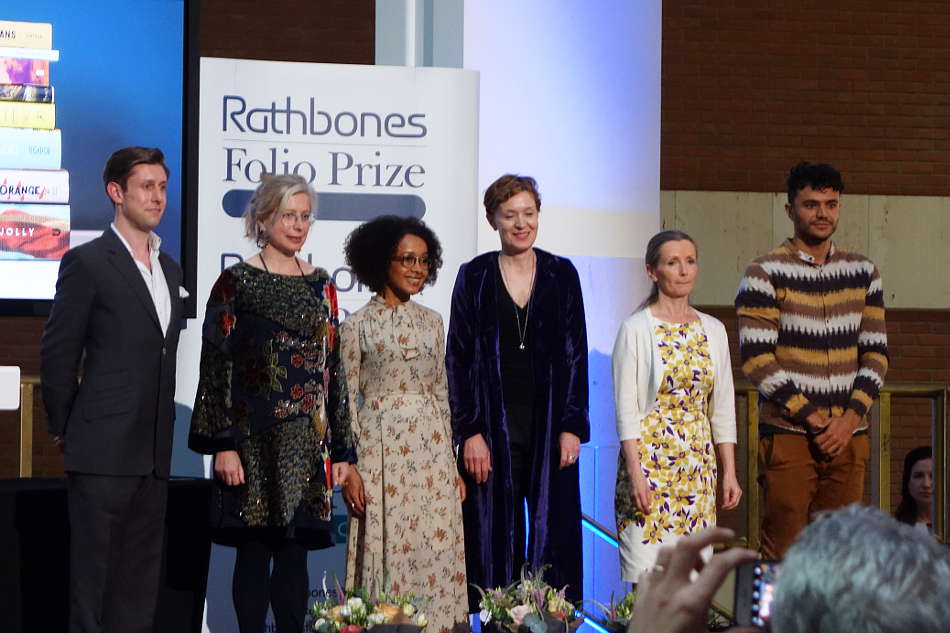 A photograph of Guy Stagg, Alice Jolly, Diana Evans, Carys Davis, Anna Burns, and Raymond Antrobus on the Rathbones Folio stage