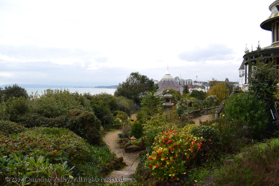 A photograph of the garden from the perspective of the building - we look down towards the sea